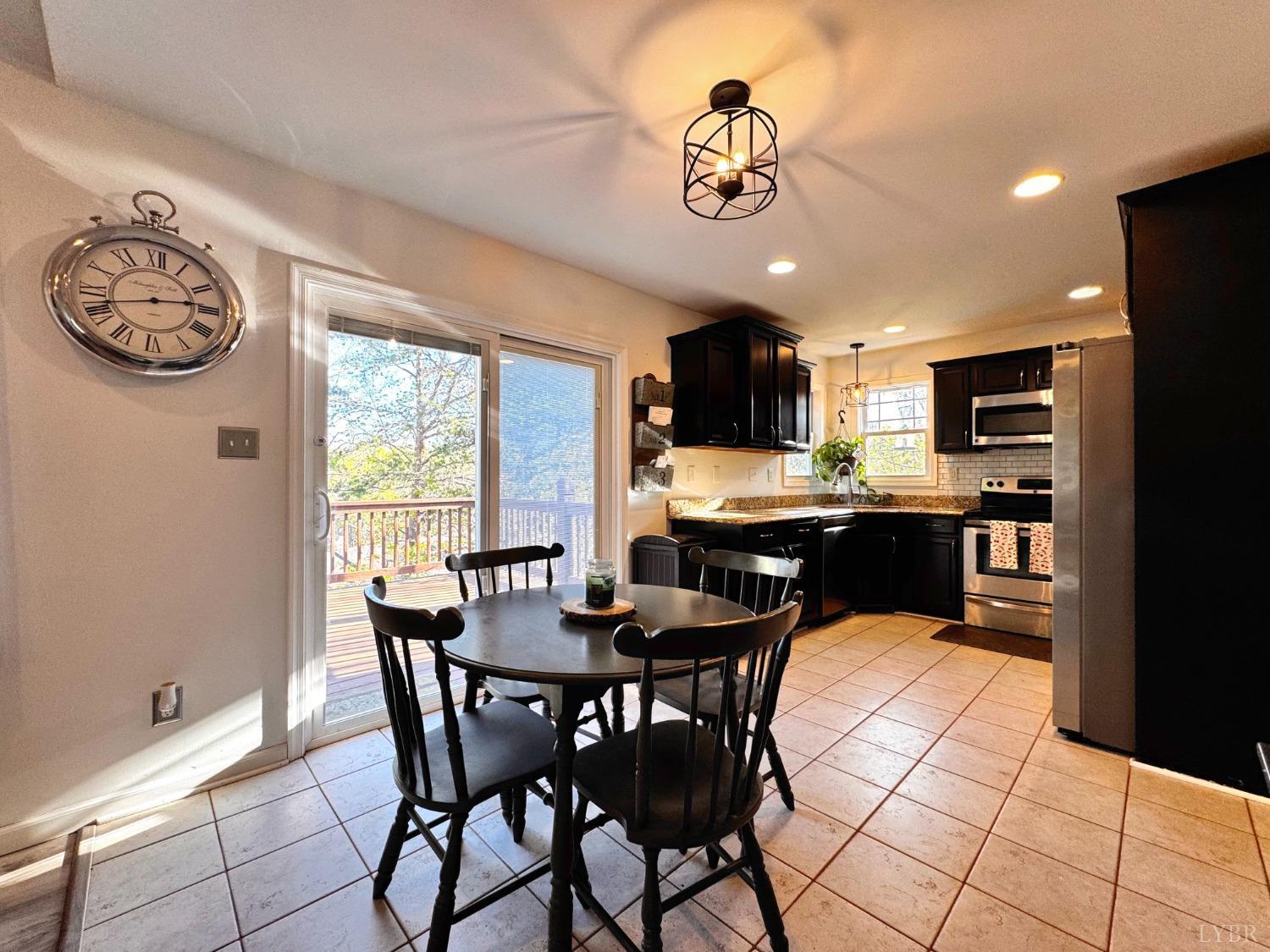 2312 Matthew Talbot Road Forest, VA 24551 - Photo 5 of 36 a view of a dining room with furniture a kitchen and chandelier