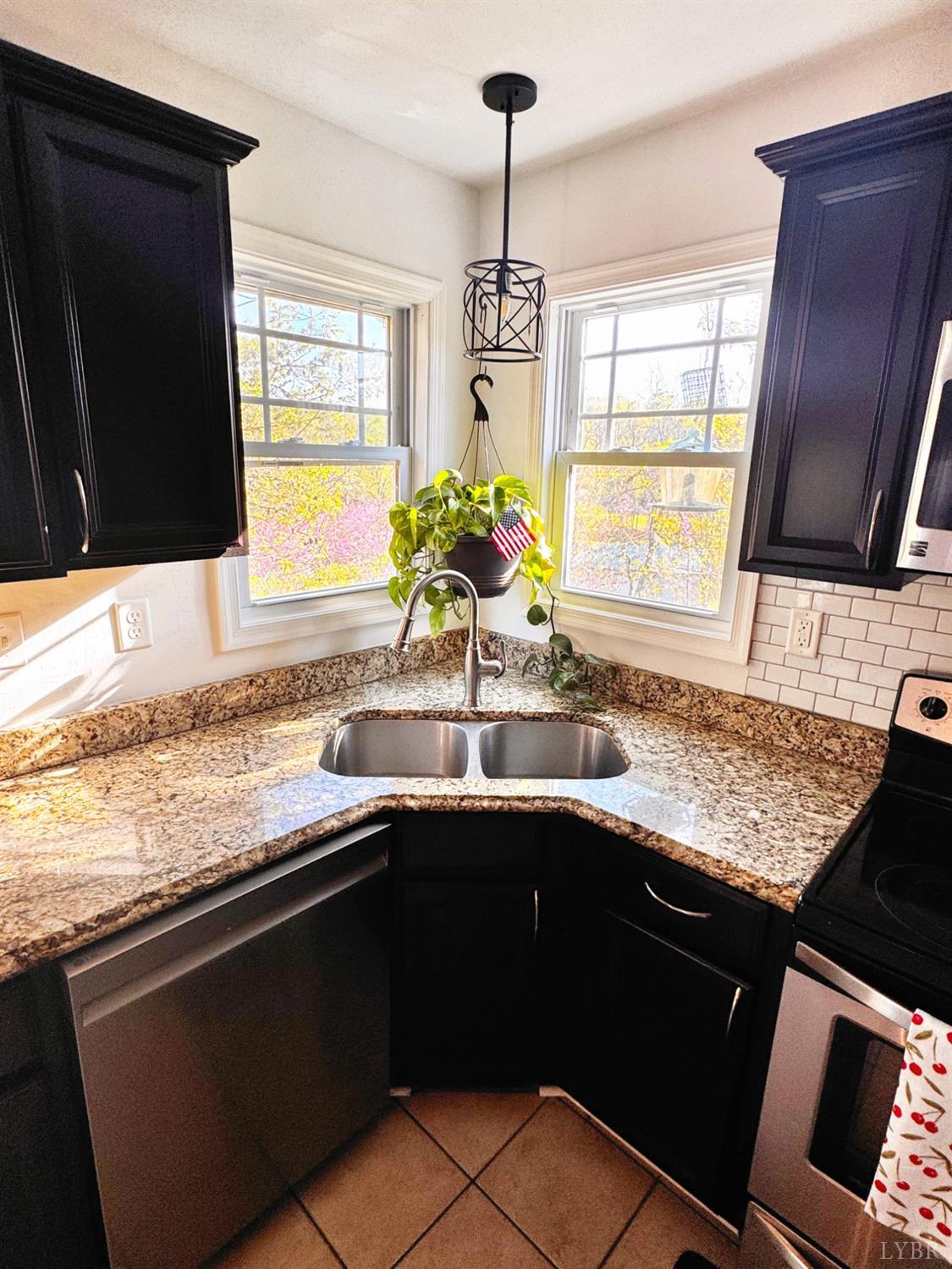 2312 Matthew Talbot Road Forest, VA 24551 - Photo 8 of 36 a kitchen with granite countertop a sink stainless steel appliances and a window