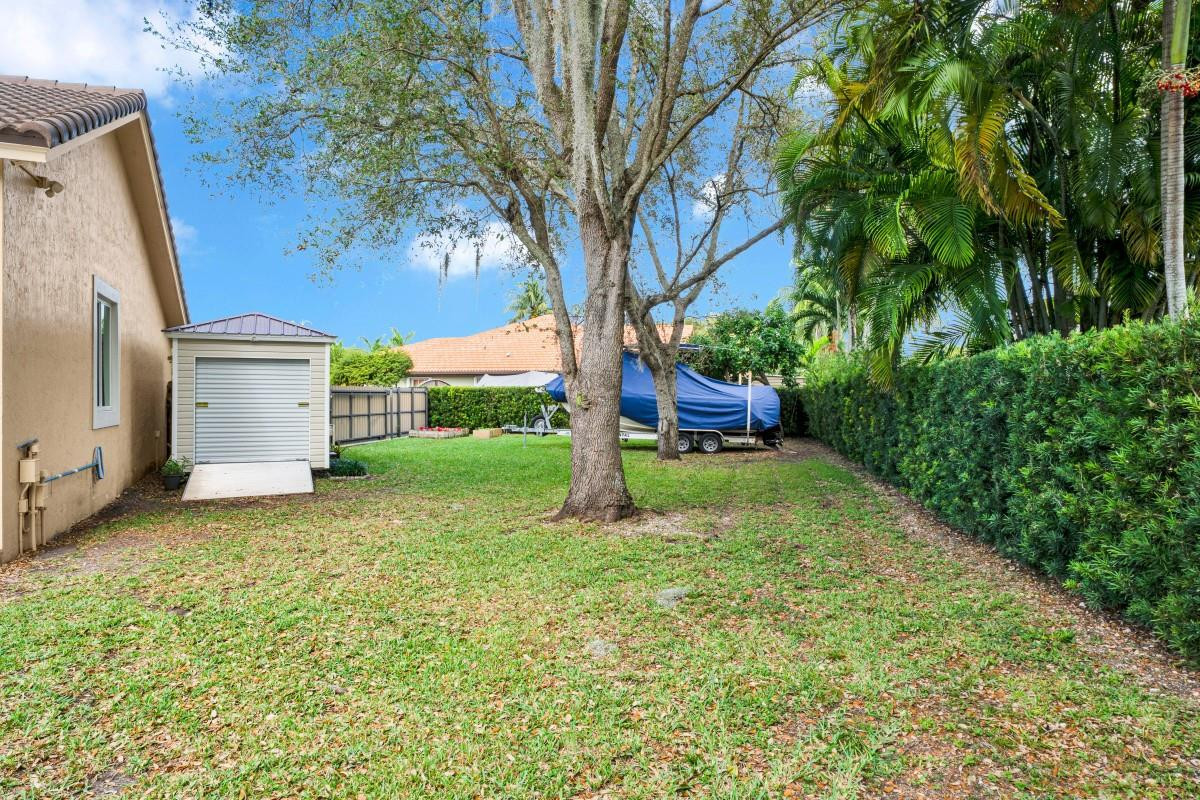 14809 Southwest 154th Court Miami, FL 33196 - Photo 27 of 30 a house is sitting in middle od the grass