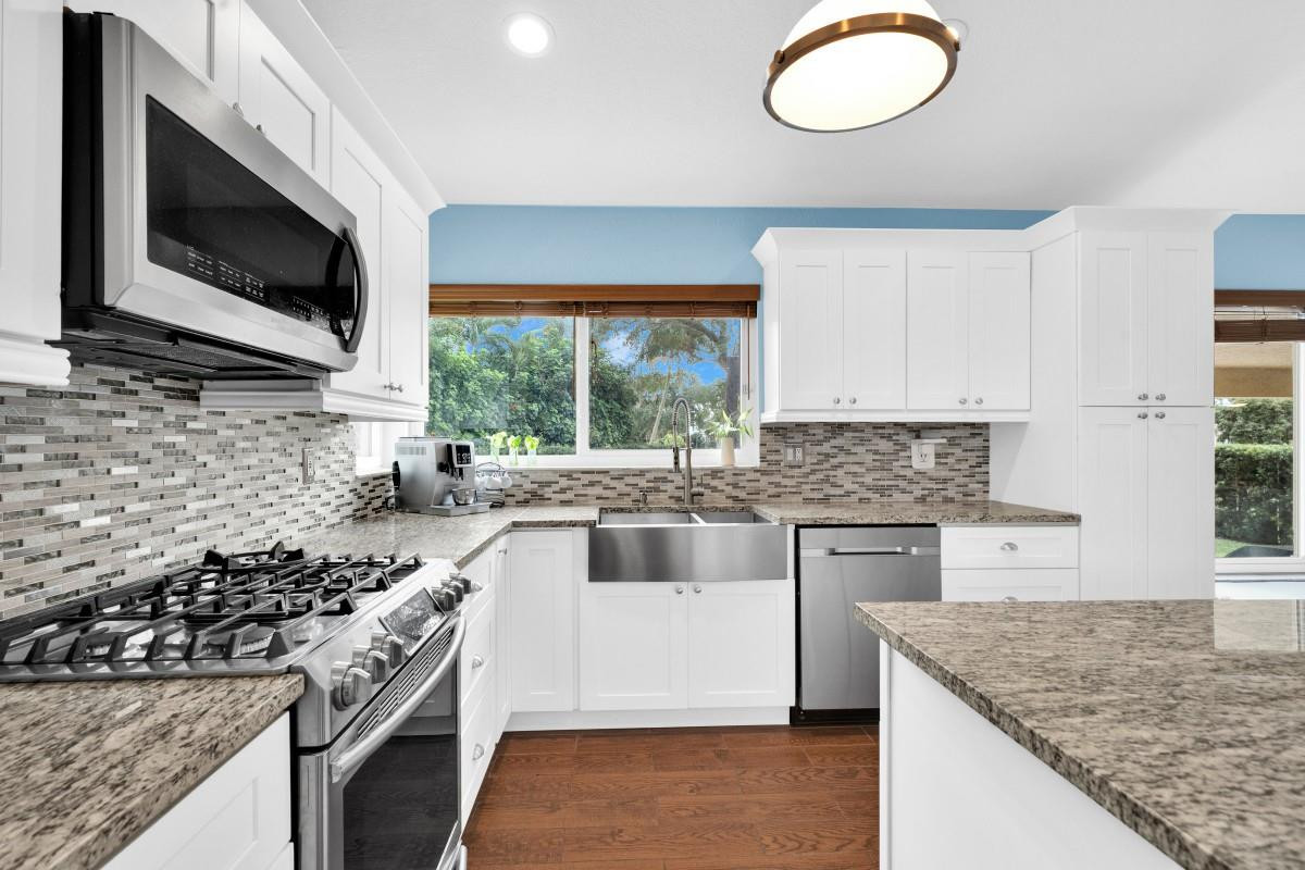 14809 Southwest 154th Court Miami, FL 33196 - Photo 9 of 30 a kitchen with stainless steel appliances granite countertop a sink and a stove