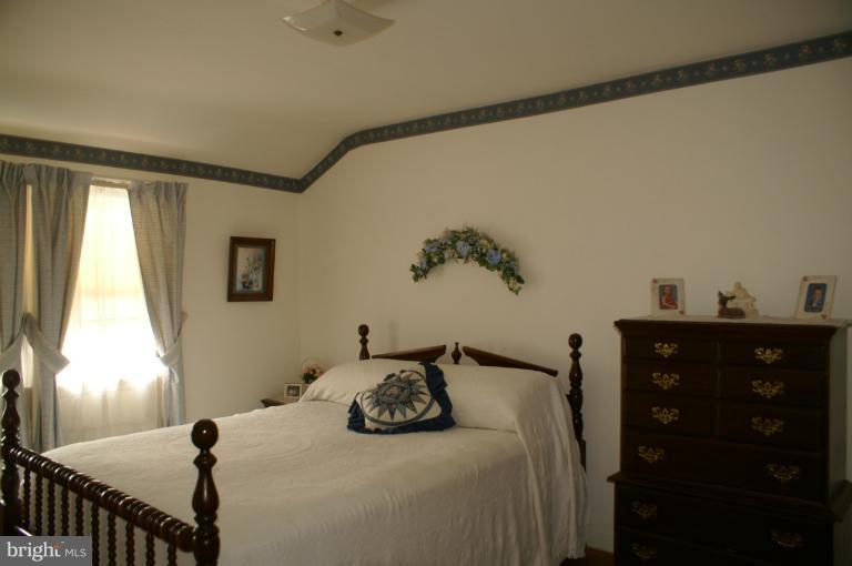 802 Arncliffe Road Baltimore, MD 21221 - Photo 3 of 27 a bedroom with a bed and a window