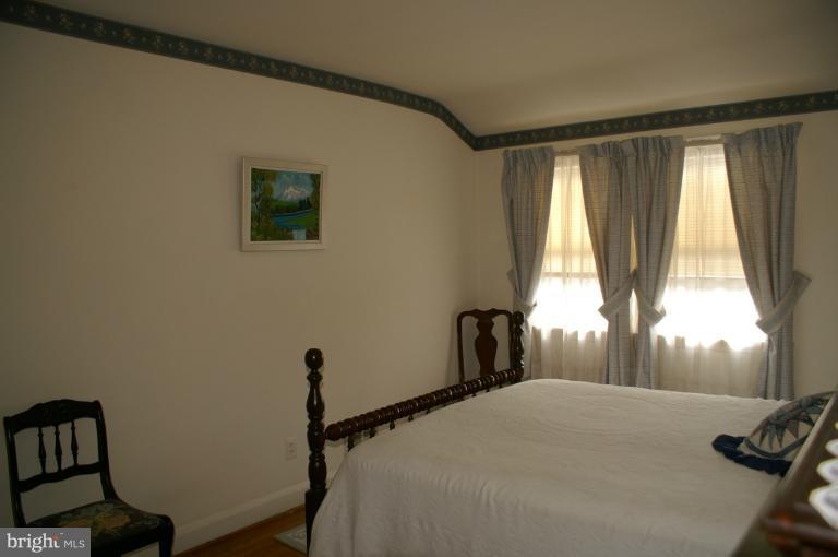 802 Arncliffe Road Baltimore, MD 21221 - Photo 4 of 27 a bedroom with a bed and a window