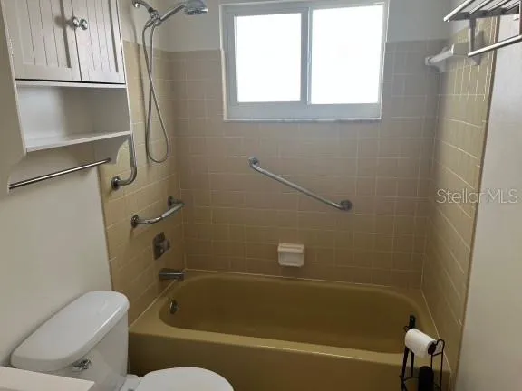 a bathroom with a toilet bathtub and shower