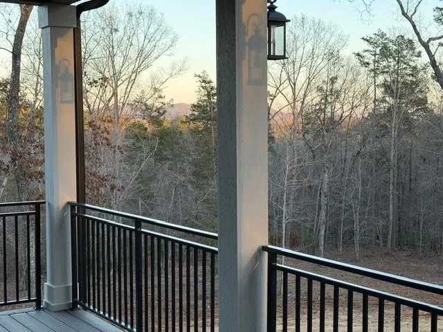a view of a balcony with trees