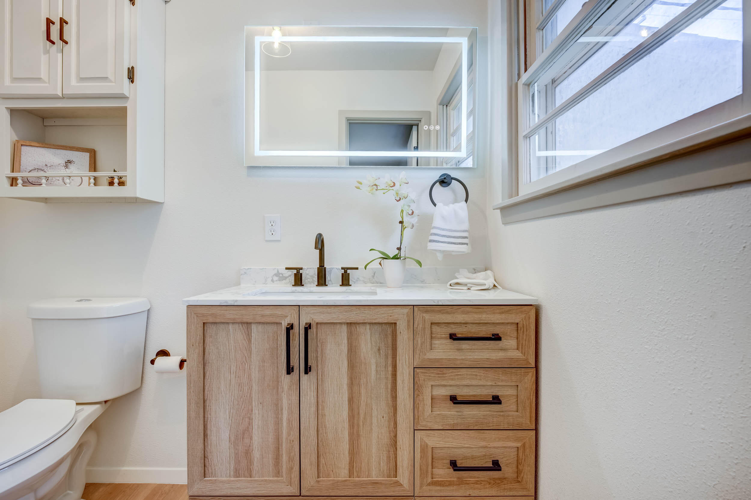 2101 64th Street Lubbock, TX 79412 - Photo 20 of 30 a bathroom with a sink a toilet and vanity
