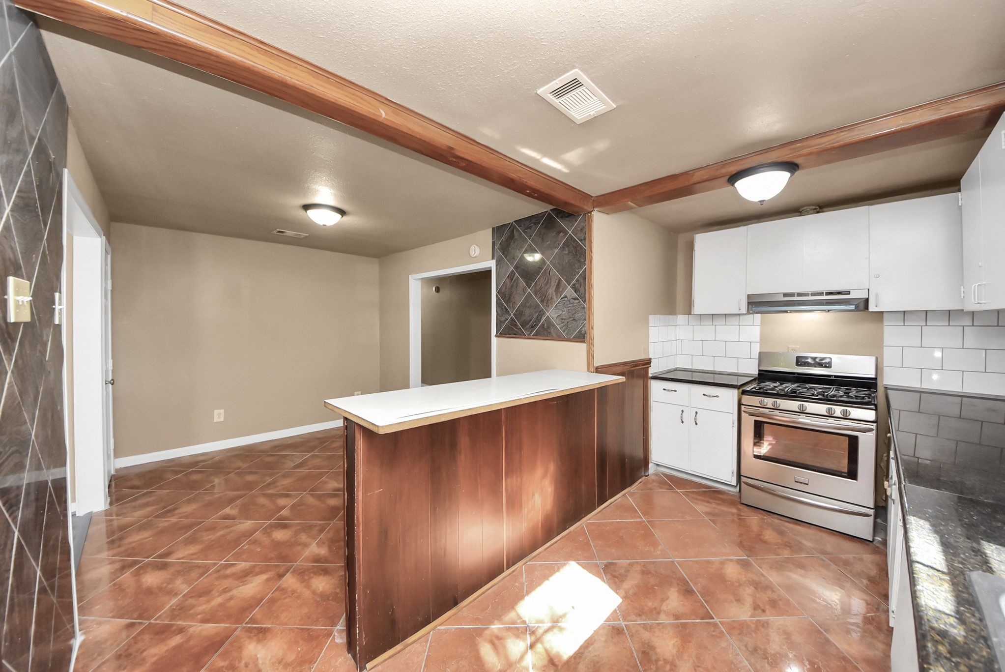 2510 Delaware Avenue League City, TX 77573 - Photo 12 of 38 a kitchen with stainless steel appliances granite countertop a stove a sink and a refrigerator