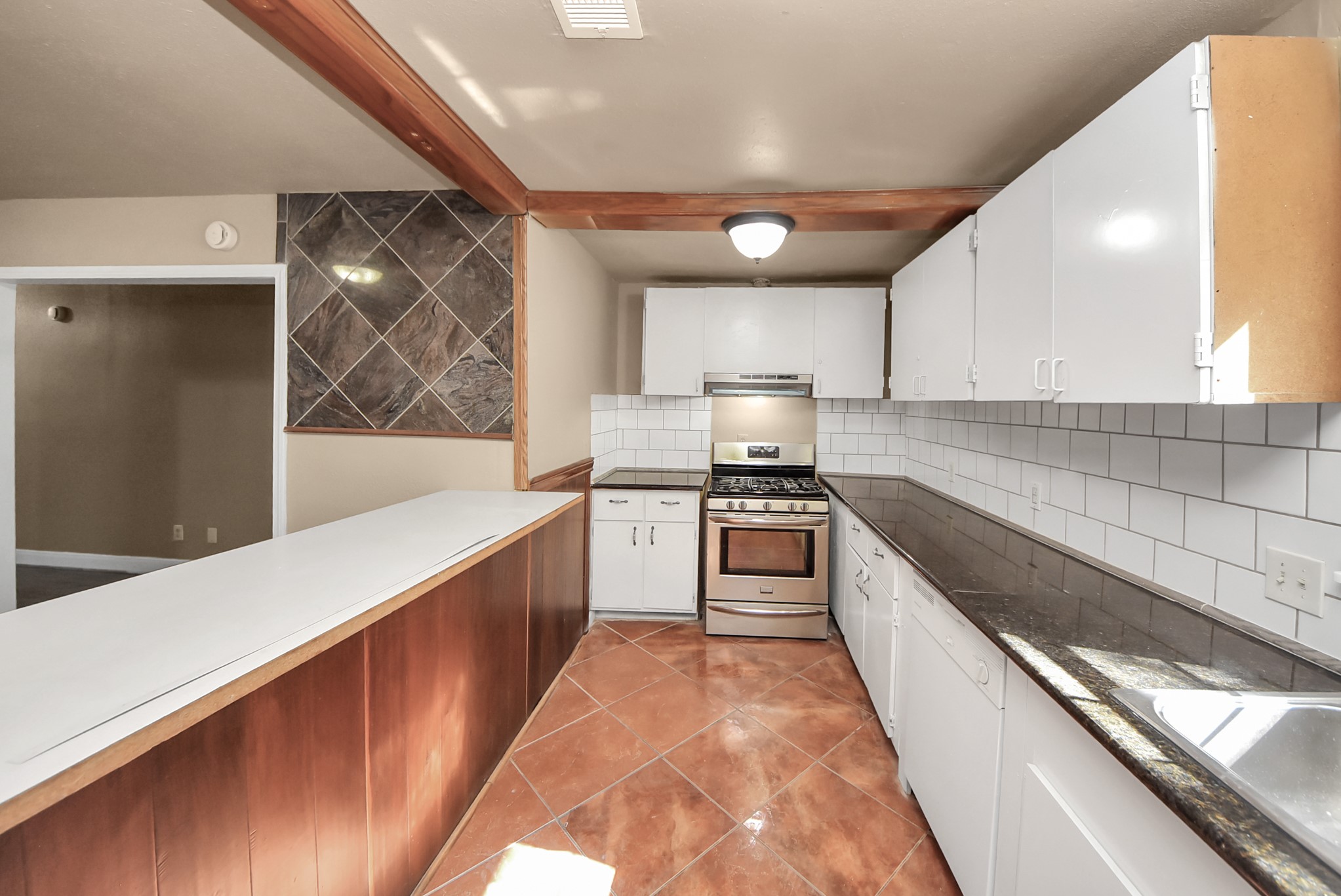 2510 Delaware Avenue League City, TX 77573 - Photo 13 of 38 a kitchen with granite countertop white cabinets and white appliances