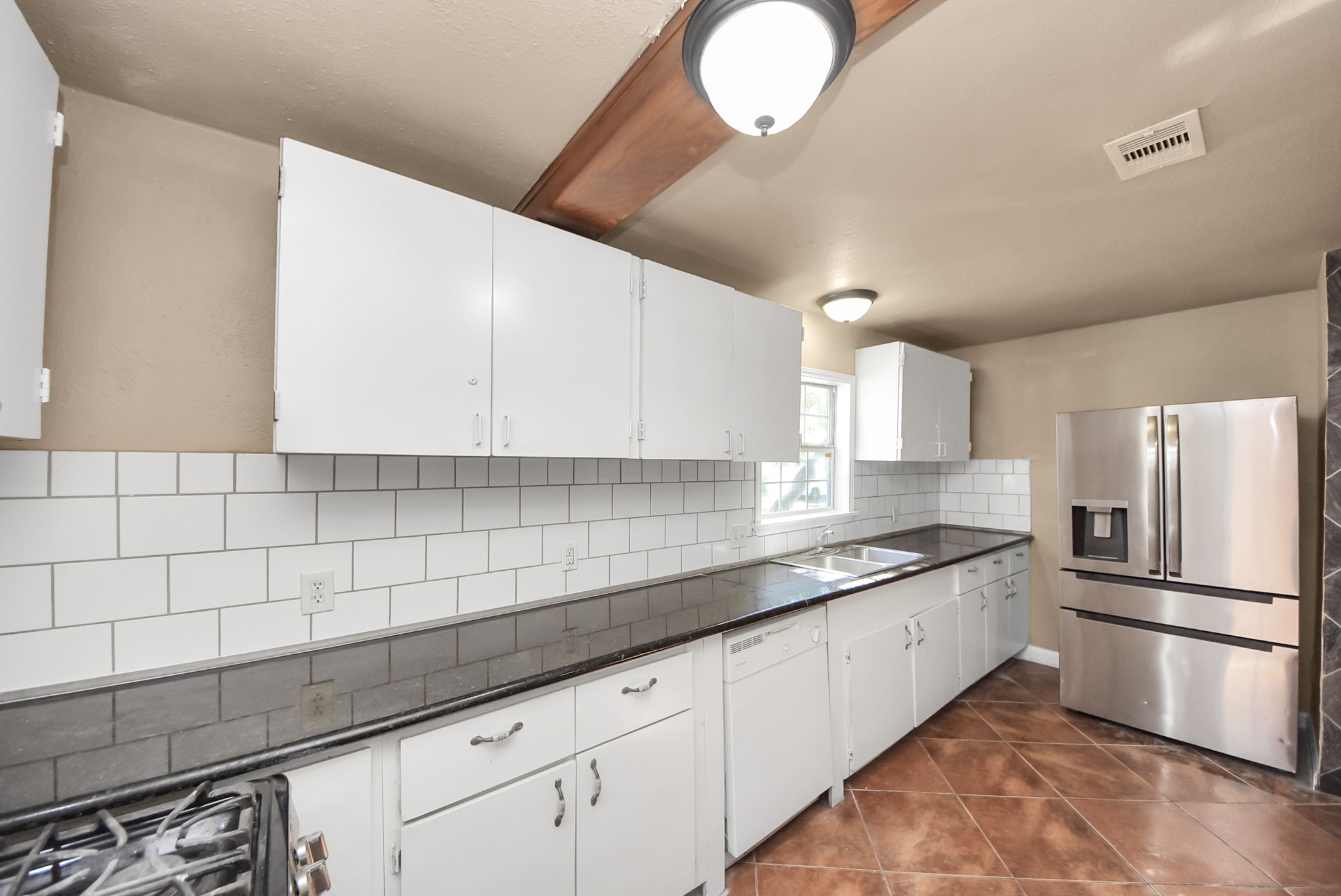 2510 Delaware Avenue League City, TX 77573 - Photo 14 of 38 a kitchen with a sink stainless steel appliances and cabinets