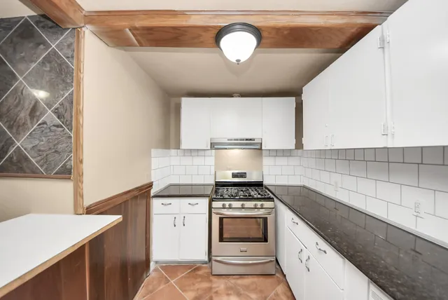 a kitchen with a stove a sink and a refrigerator