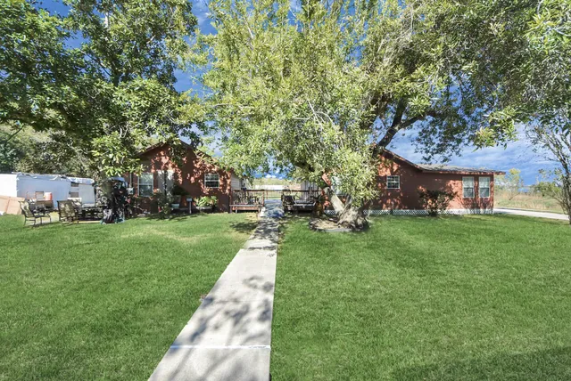 a view of a house with a backyard