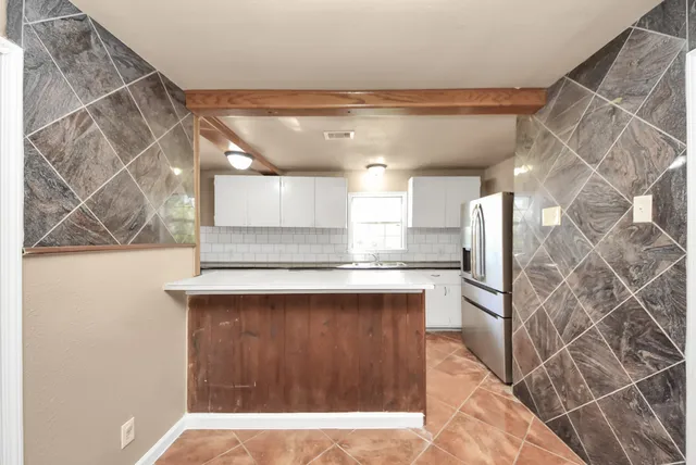 a kitchen with a sink and cabinets