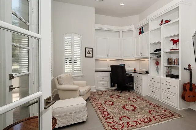 a room with a workspace and a window