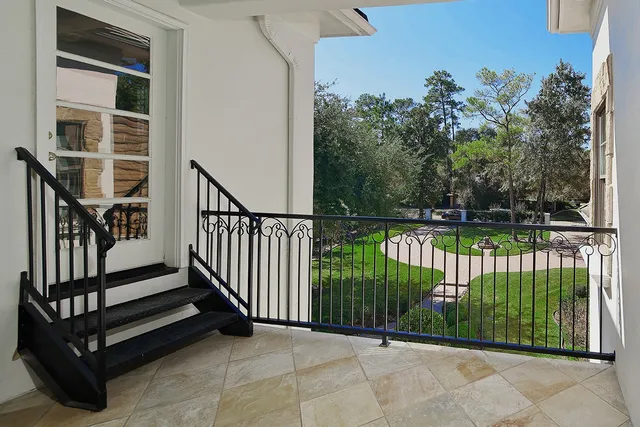 a view of a porch with a floor to ceiling window and wooden fence