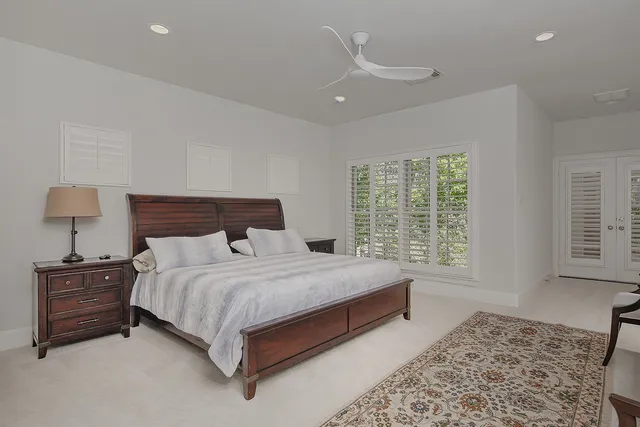 a large bed sitting in a bedroom next to a window