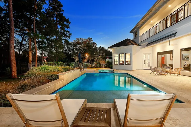 a view of swimming pool with outdoor seating and plants