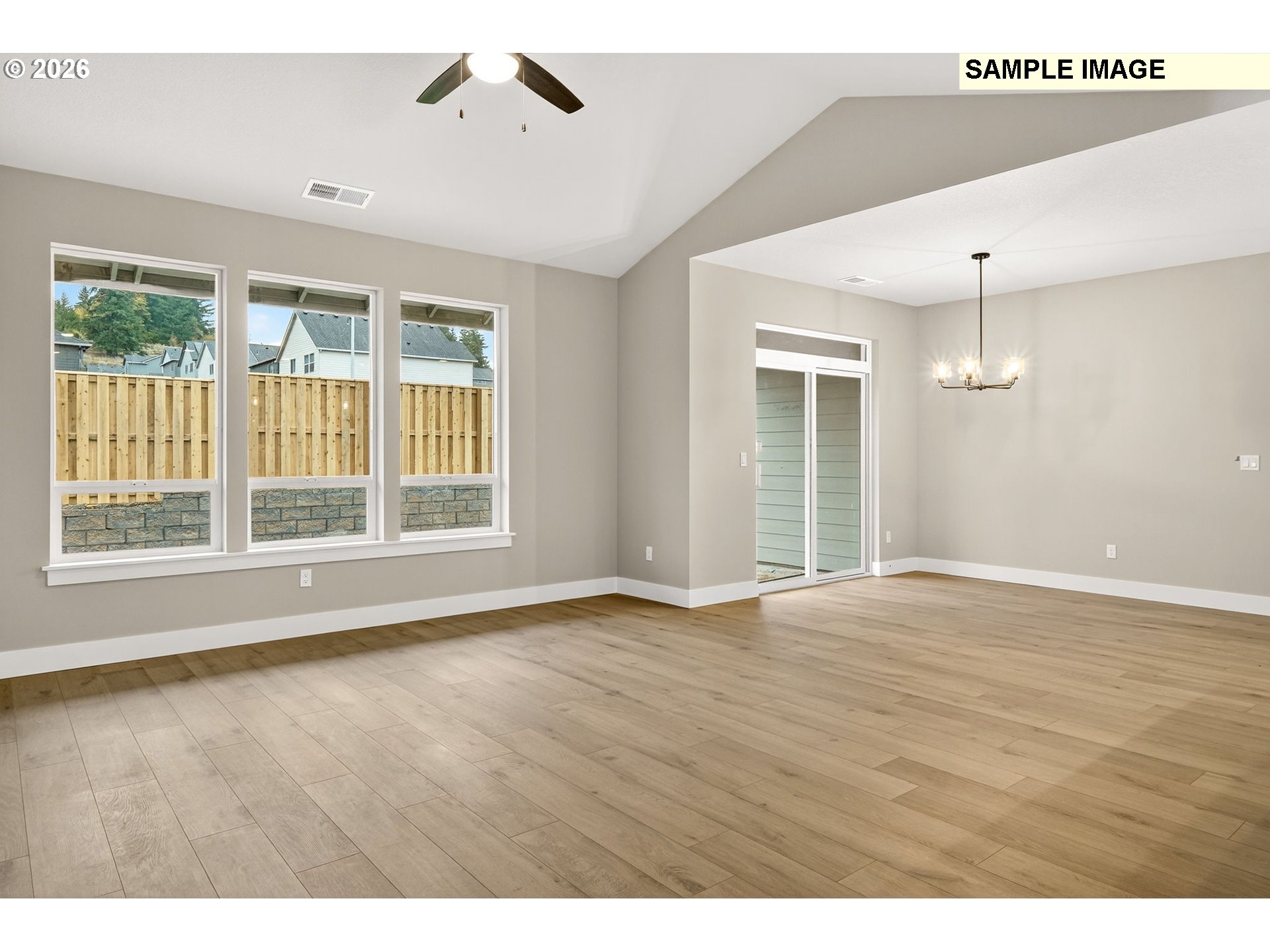 3352 Northeast Sweetwater Road, Unit 80 Estacada, OR 97023 - Photo 9 of 48 an empty room with wooden floor and windows