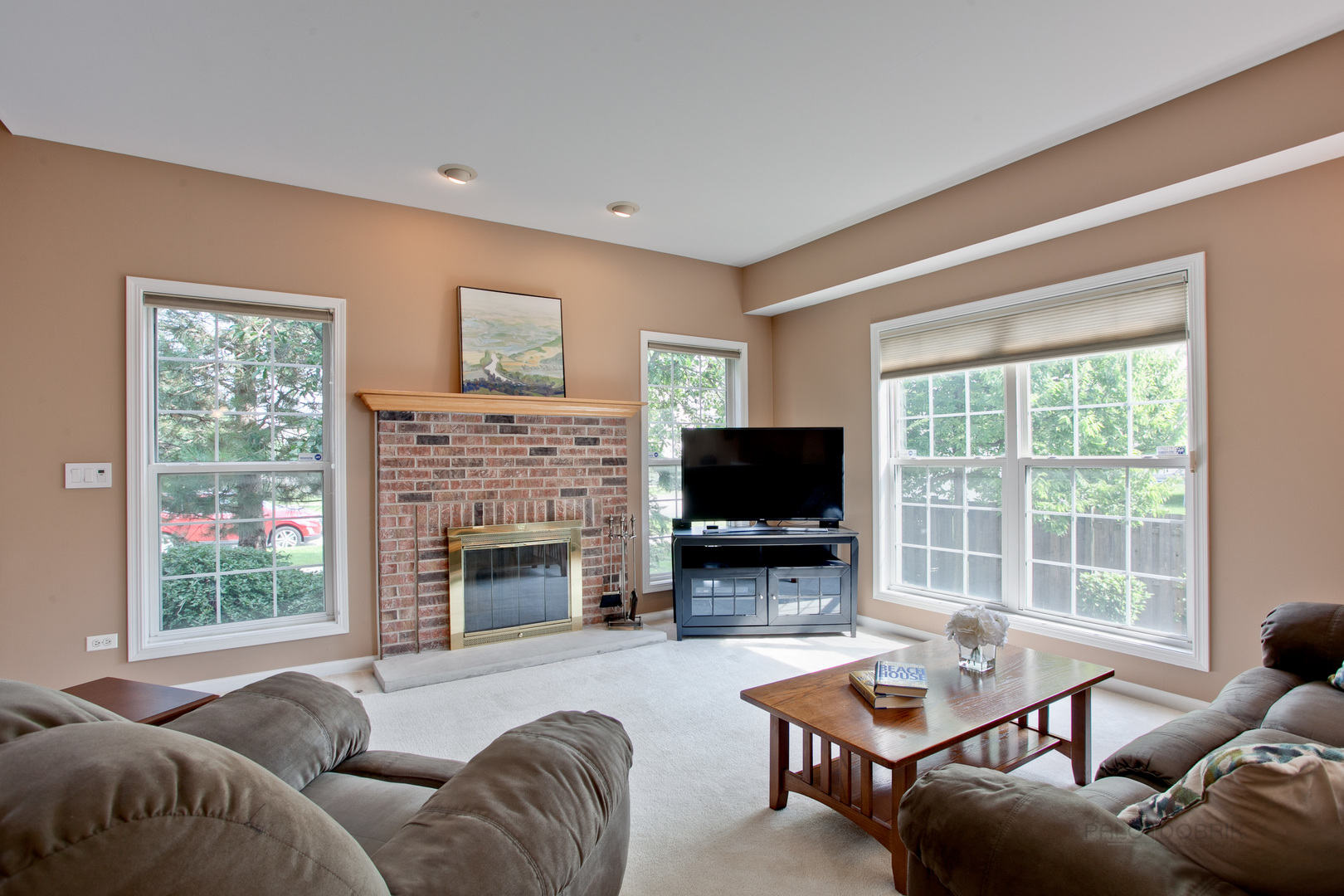 5451 McDonough Road Hoffman Estates, IL 60192 - Photo 2 of 30 a living room with furniture a fireplace and a flat screen tv