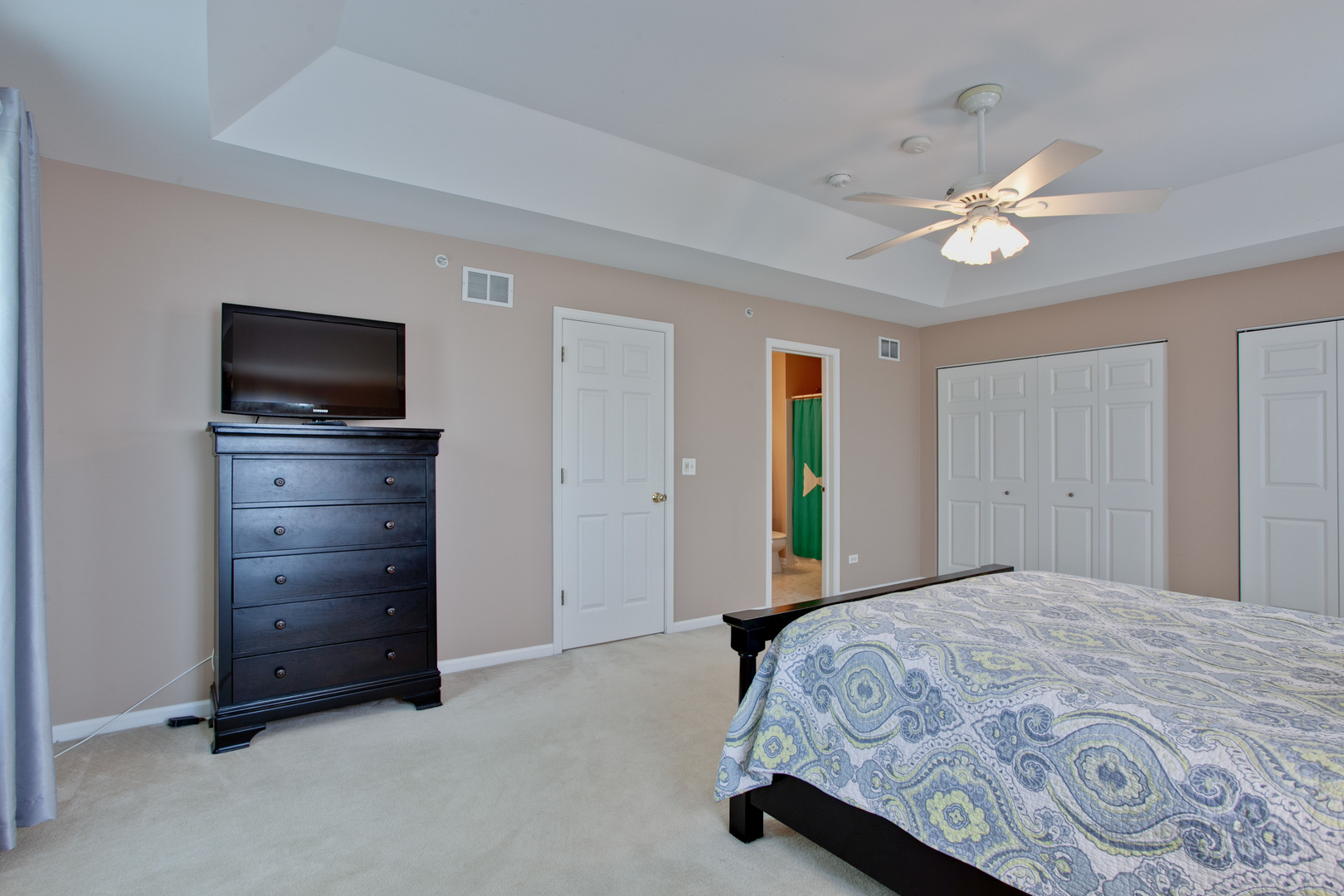 5451 McDonough Road Hoffman Estates, IL 60192 - Photo 20 of 30 a bedroom with a bed and a flat screen tv