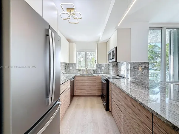 a large white kitchen with a large window