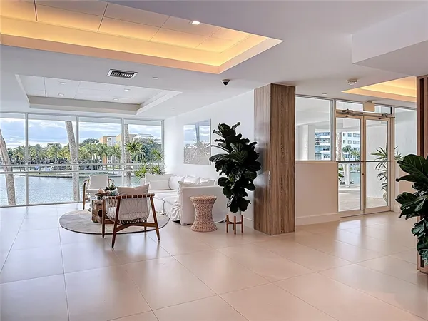 a dining hall with stainless steel appliances kitchen island granite countertop a table and chairs