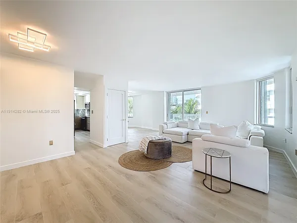 a living room with furniture window and wooden floor