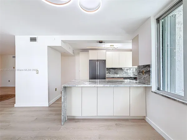 a kitchen with stainless steel appliances granite countertop a refrigerator and sink
