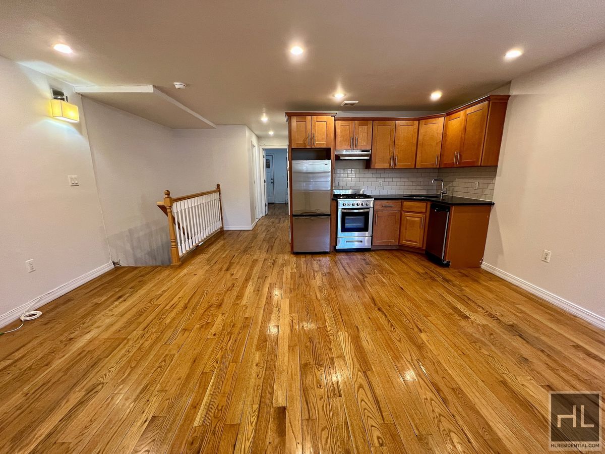 a view of kitchen with stainless steel appliances kitchen island a large island in the center