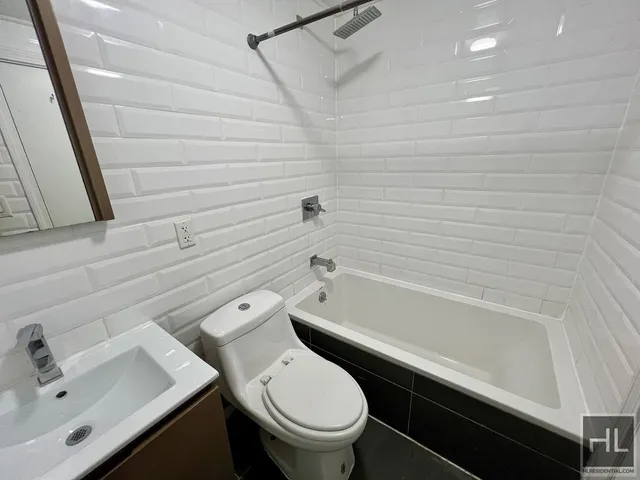a bathroom with a sink a toilet and bathtub