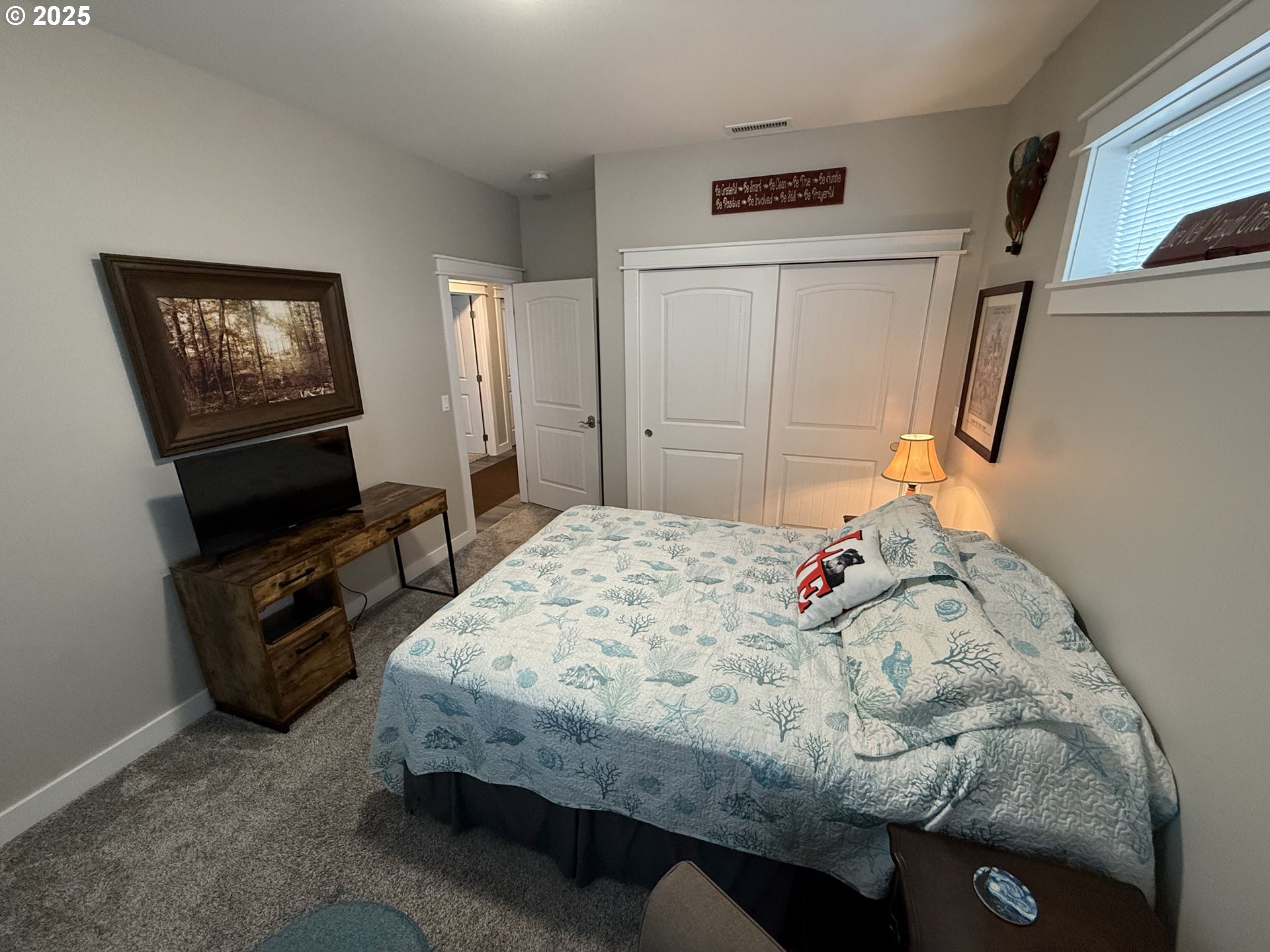 4055 Caddington Lane Florence, OR 97439 - Photo 11 of 48 a bedroom with a bed and a tv on the dresser