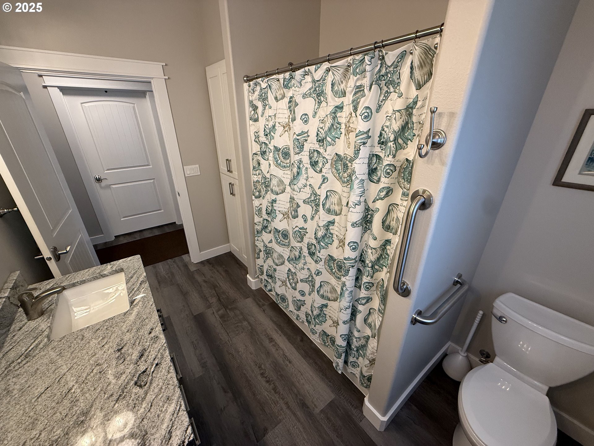 4055 Caddington Lane Florence, OR 97439 - Photo 15 of 48 a bathroom with a toilet and shower curtain