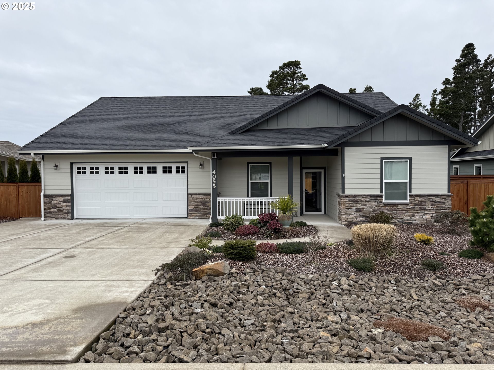 4055 Caddington Lane Florence, OR 97439 - Photo 2 of 48 a front view of a house with garden