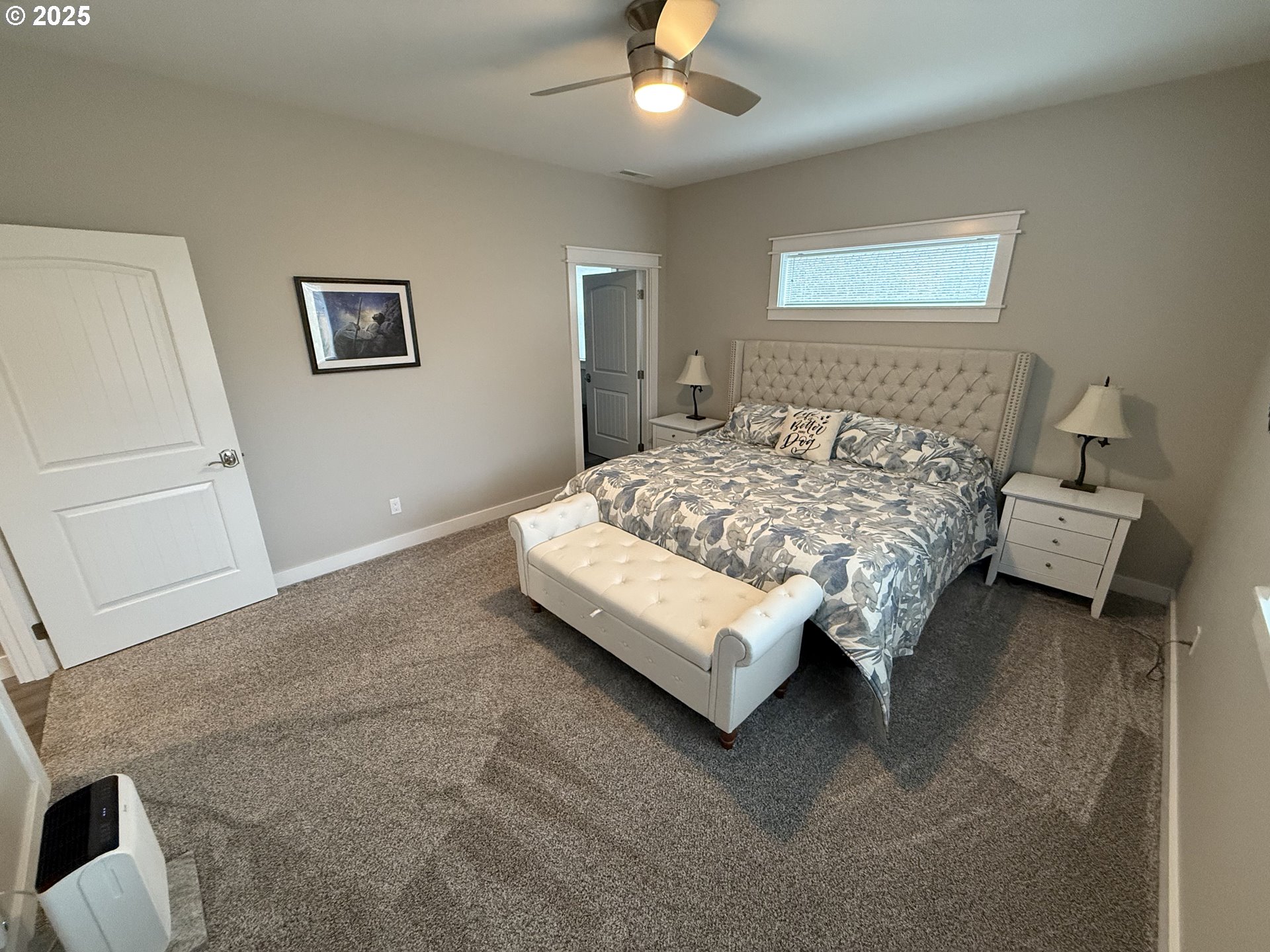 4055 Caddington Lane Florence, OR 97439 - Photo 27 of 48 a bedroom with a bed and a chandelier