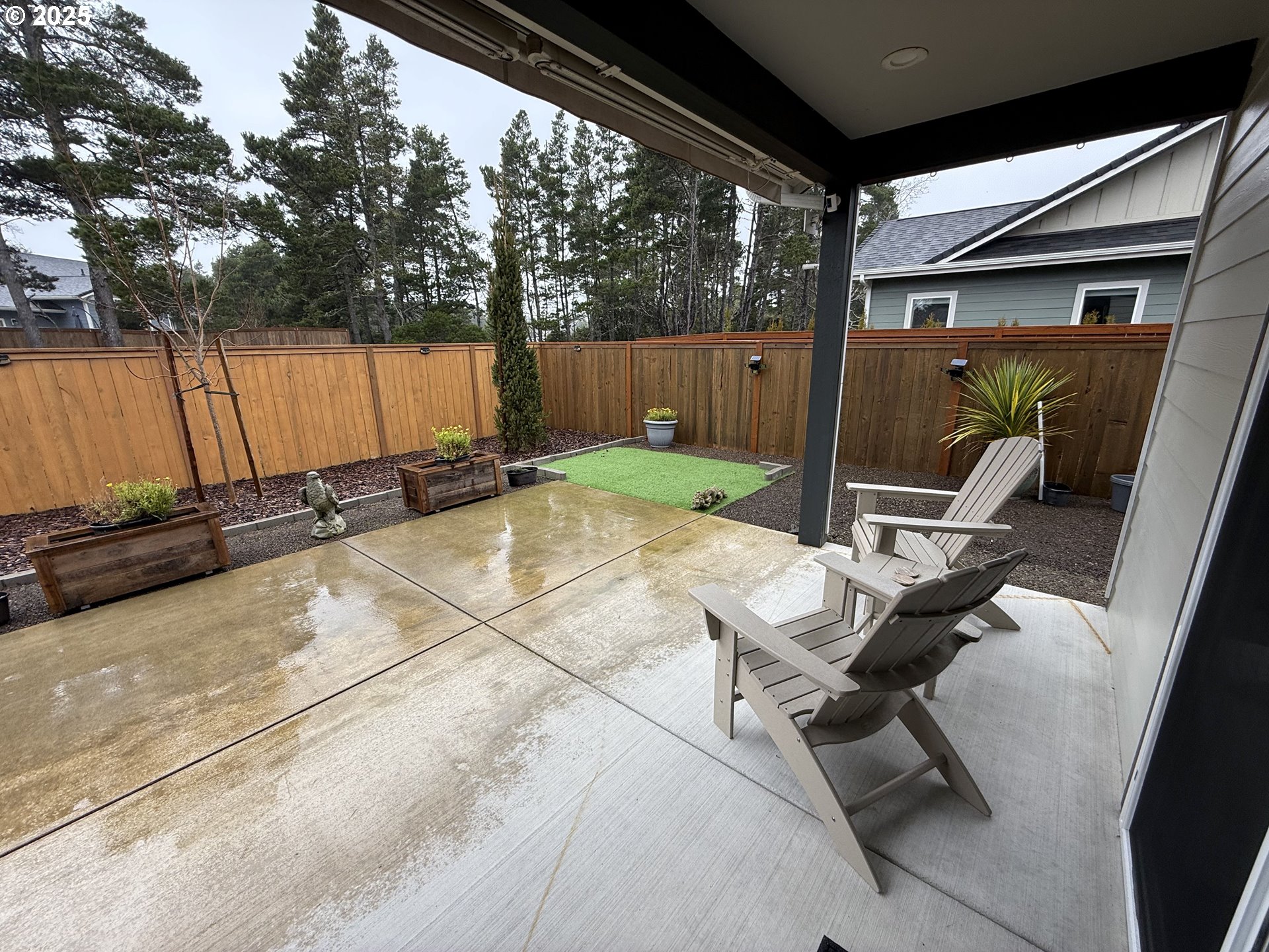 4055 Caddington Lane Florence, OR 97439 - Photo 35 of 48 a backyard of a house with barbeque oven table and chairs