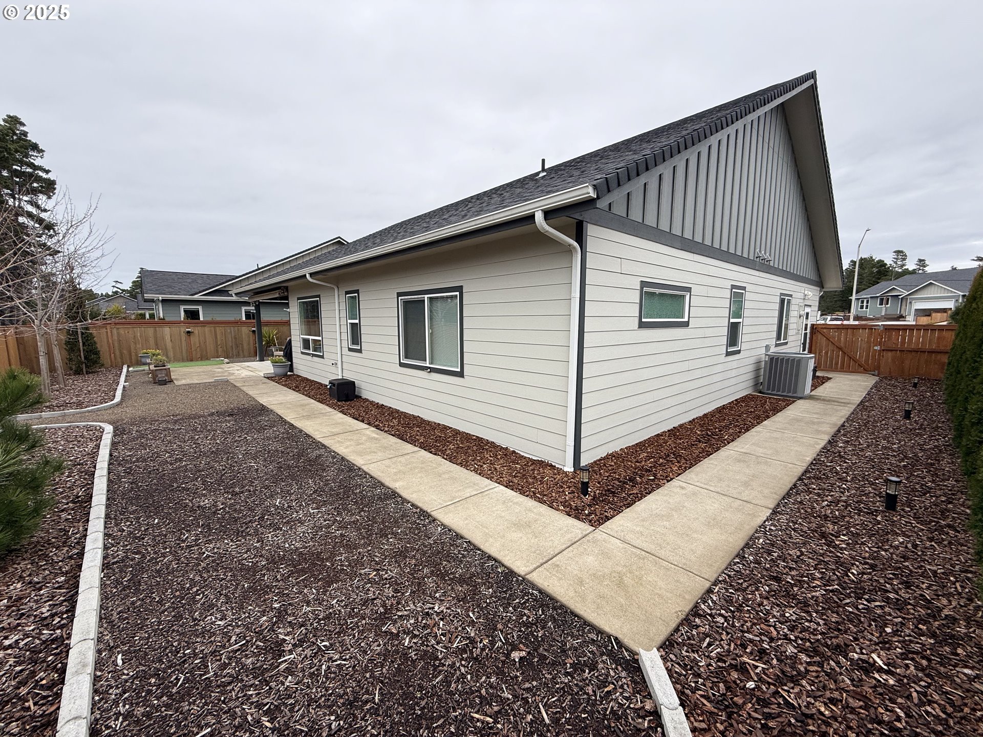 4055 Caddington Lane Florence, OR 97439 - Photo 37 of 48 a backyard of a house with large trees