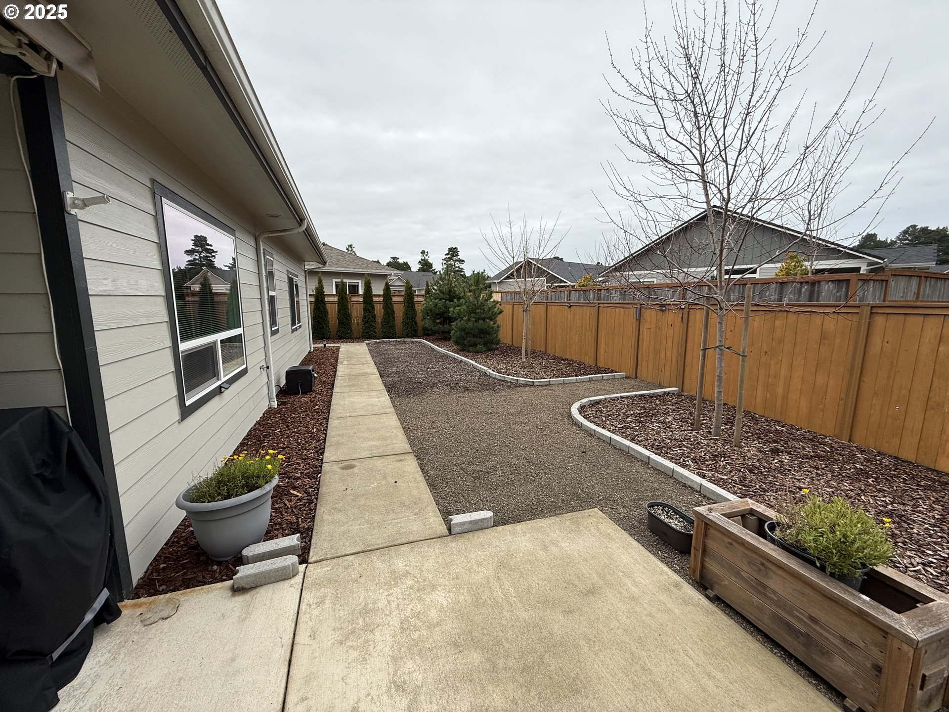 4055 Caddington Lane Florence, OR 97439 - Photo 38 of 48 a terrace with a bench and trees