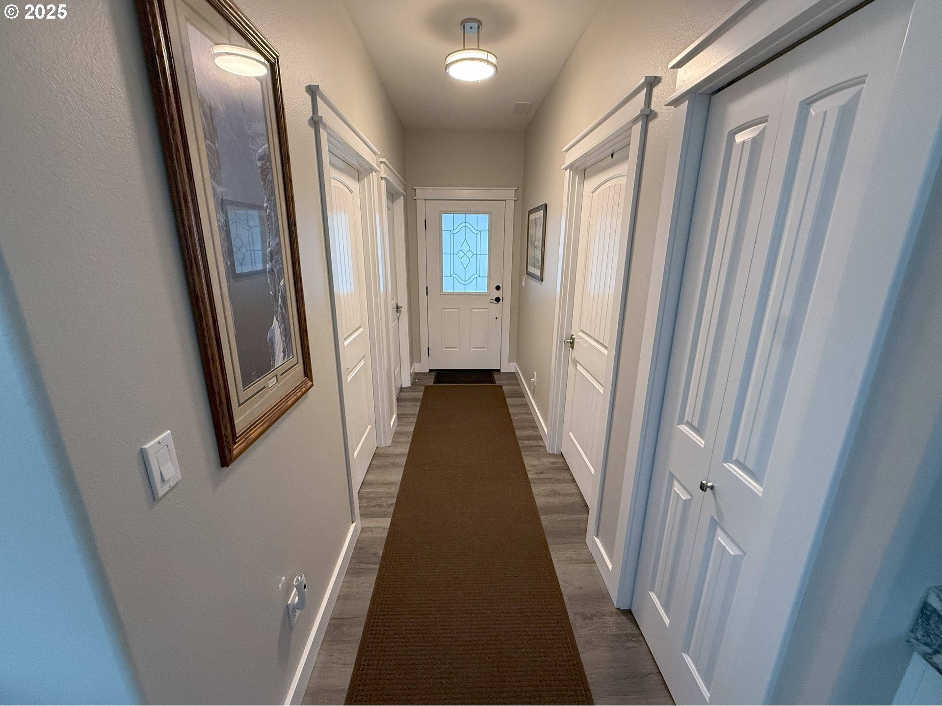 4055 Caddington Lane Florence, OR 97439 - Photo 6 of 48 a view of a hallway with wooden floor and staircase