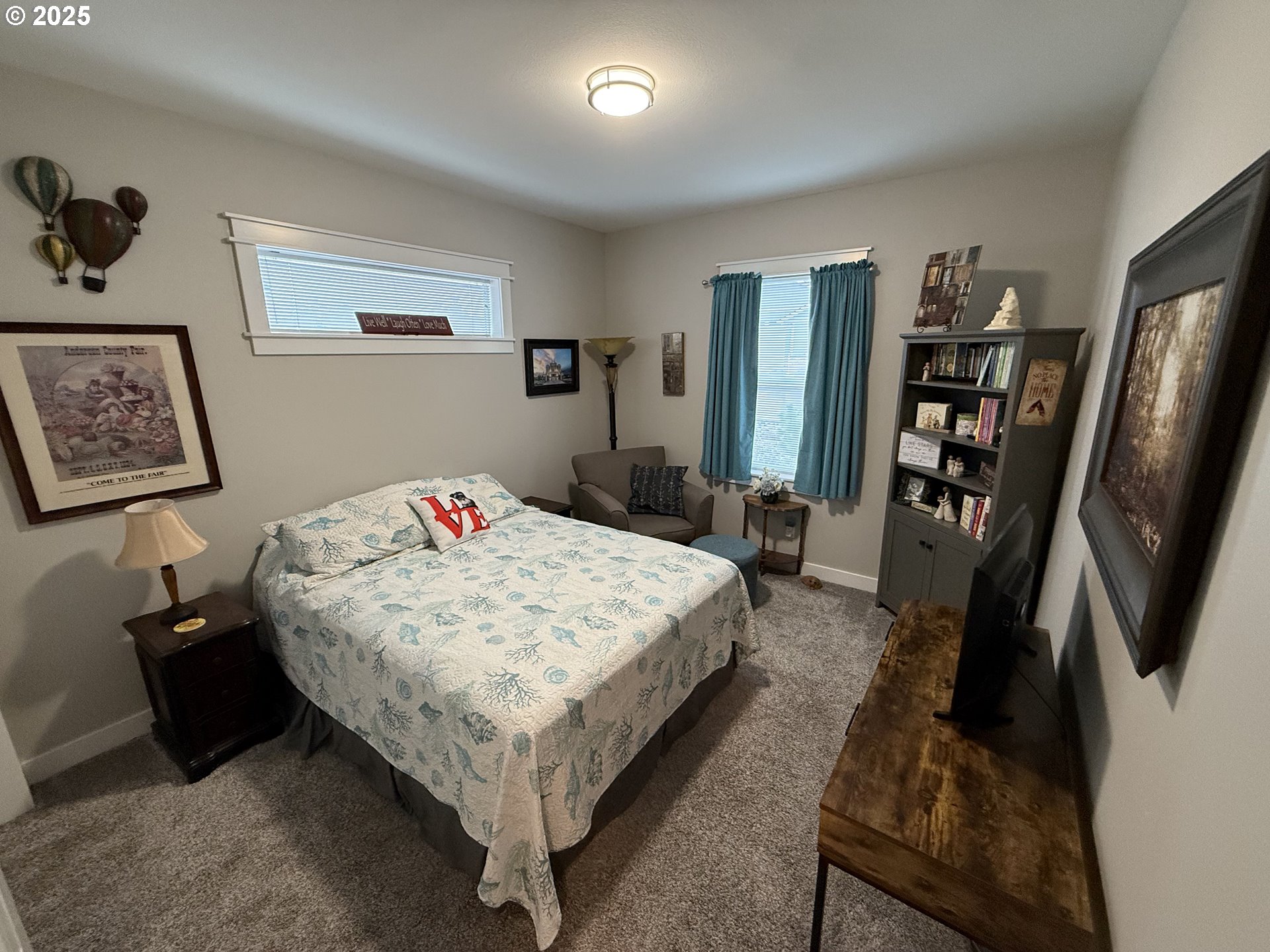 4055 Caddington Lane Florence, OR 97439 - Photo 10 of 48 a bed sitting in a bedroom next to a window