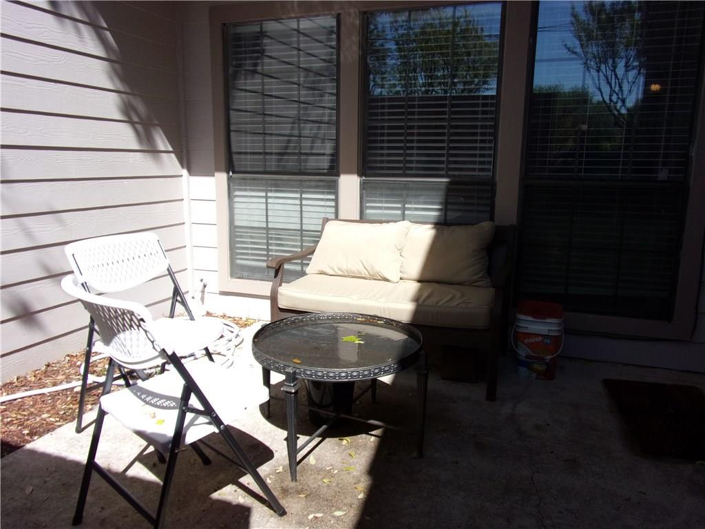 18240 Midway Road, Unit 105 Dallas, TX 75287 - Photo 30 of 37 a backyard of a house with table and chairs
