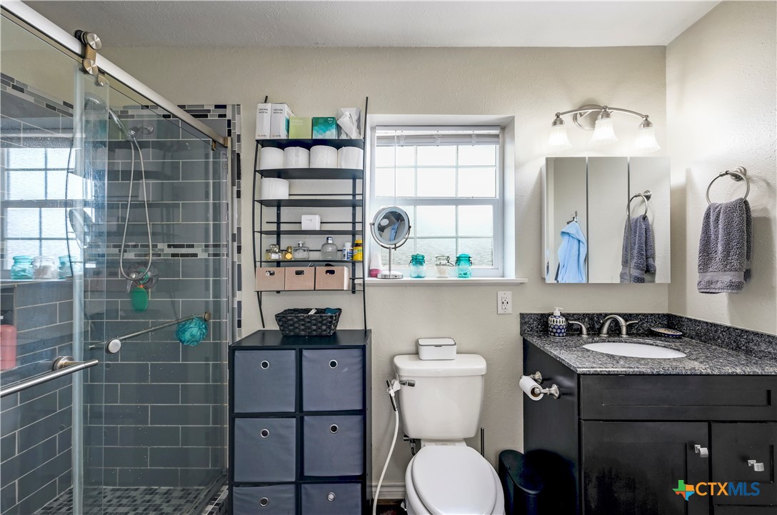 2283 Schwab Road Seguin, TX 78155 - Photo 13 of 40 a bathroom with a sink a toilet and shower