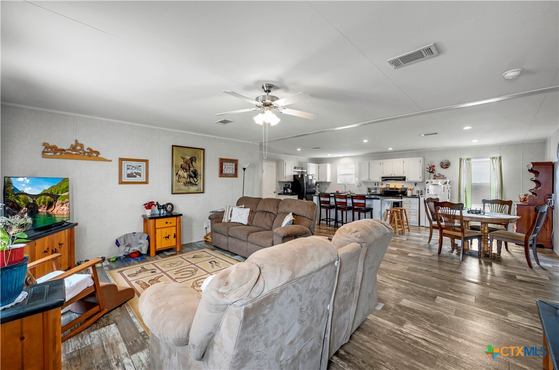 2283 Schwab Road Seguin, TX 78155 - Photo 19 of 40 a living room with furniture kitchen view and a chandelier