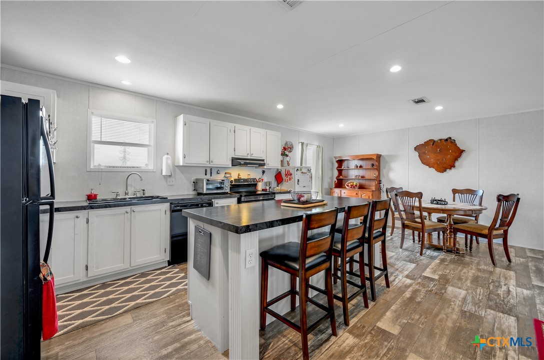 2283 Schwab Road Seguin, TX 78155 - Photo 22 of 40 a kitchen with stainless steel appliances granite countertop table chairs sink and cabinets