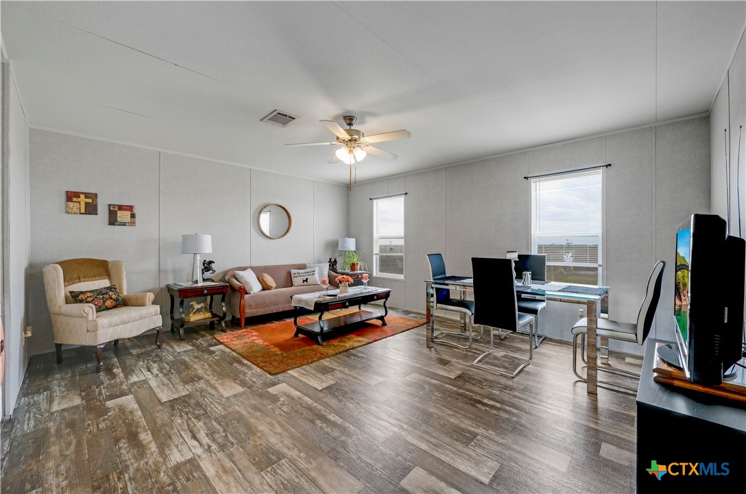 2283 Schwab Road Seguin, TX 78155 - Photo 29 of 40 a living room with furniture and a flat screen tv with wooden floor