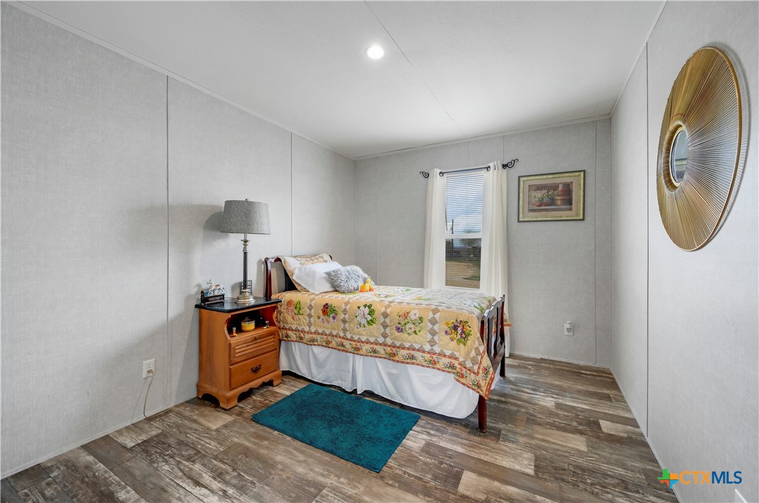 2283 Schwab Road Seguin, TX 78155 - Photo 32 of 40 a bedroom with a bed and a mirror