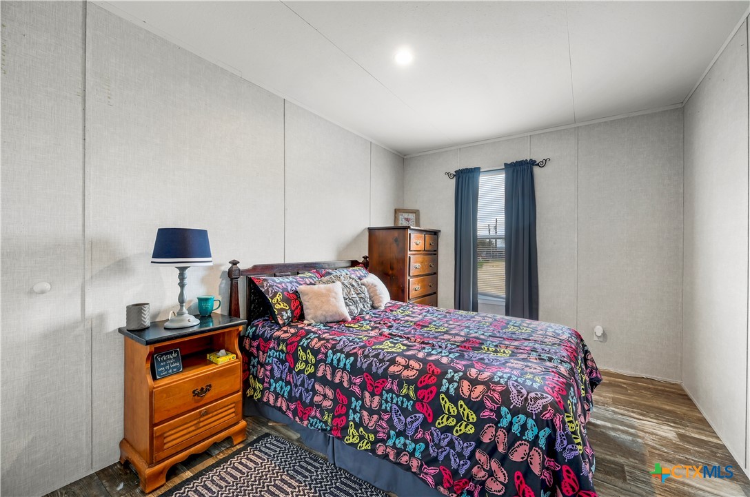 2283 Schwab Road Seguin, TX 78155 - Photo 33 of 40 a bedroom with a bed and a lamp on dresser