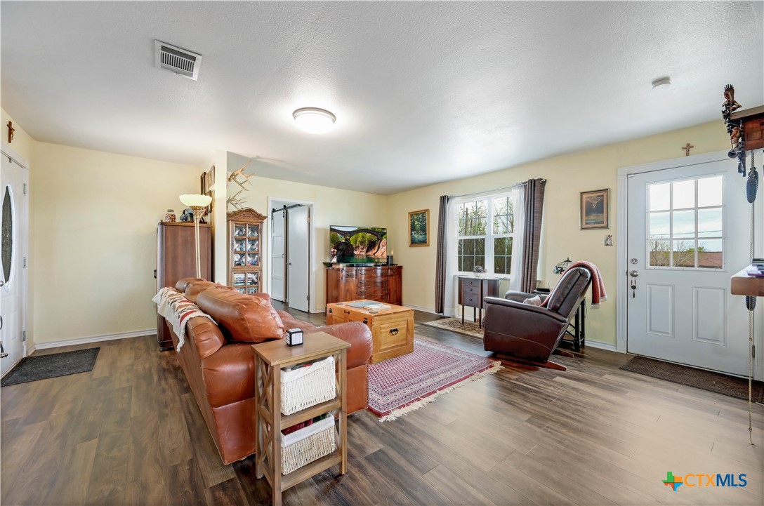 2283 Schwab Road Seguin, TX 78155 - Photo 5 of 40 a living room with furniture floor to ceiling window and wooden floor