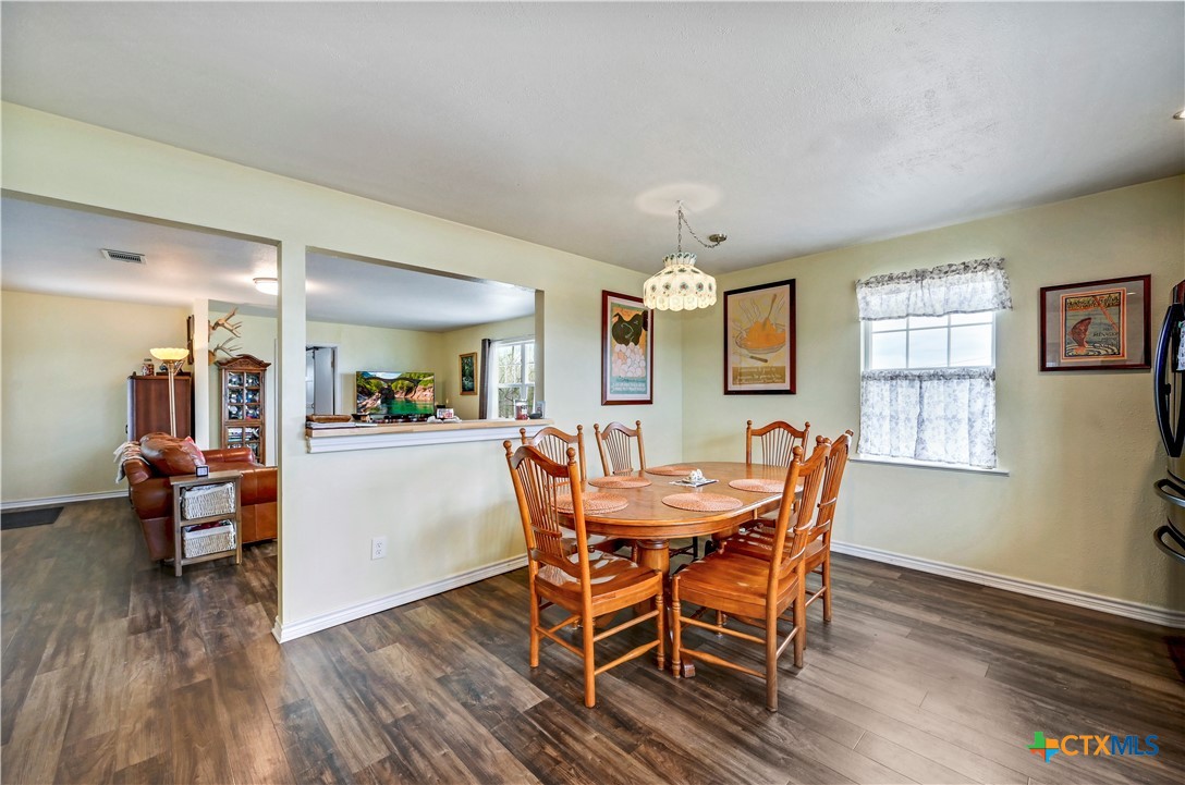 2283 Schwab Road Seguin, TX 78155 - Photo 10 of 40 a view of a dining room with furniture and wooden floor