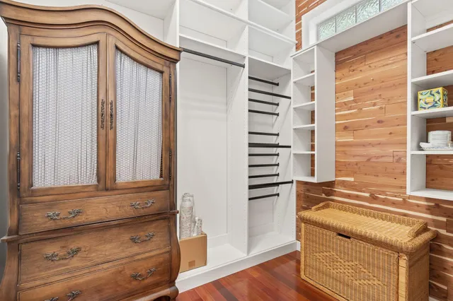 a living room with hard wood floors and a window