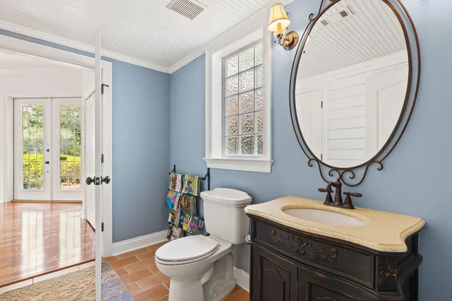 a spacious bedroom with a bed and wooden floor