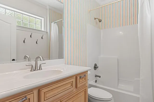 a view of a livingroom with furniture wooden floor and a fireplace