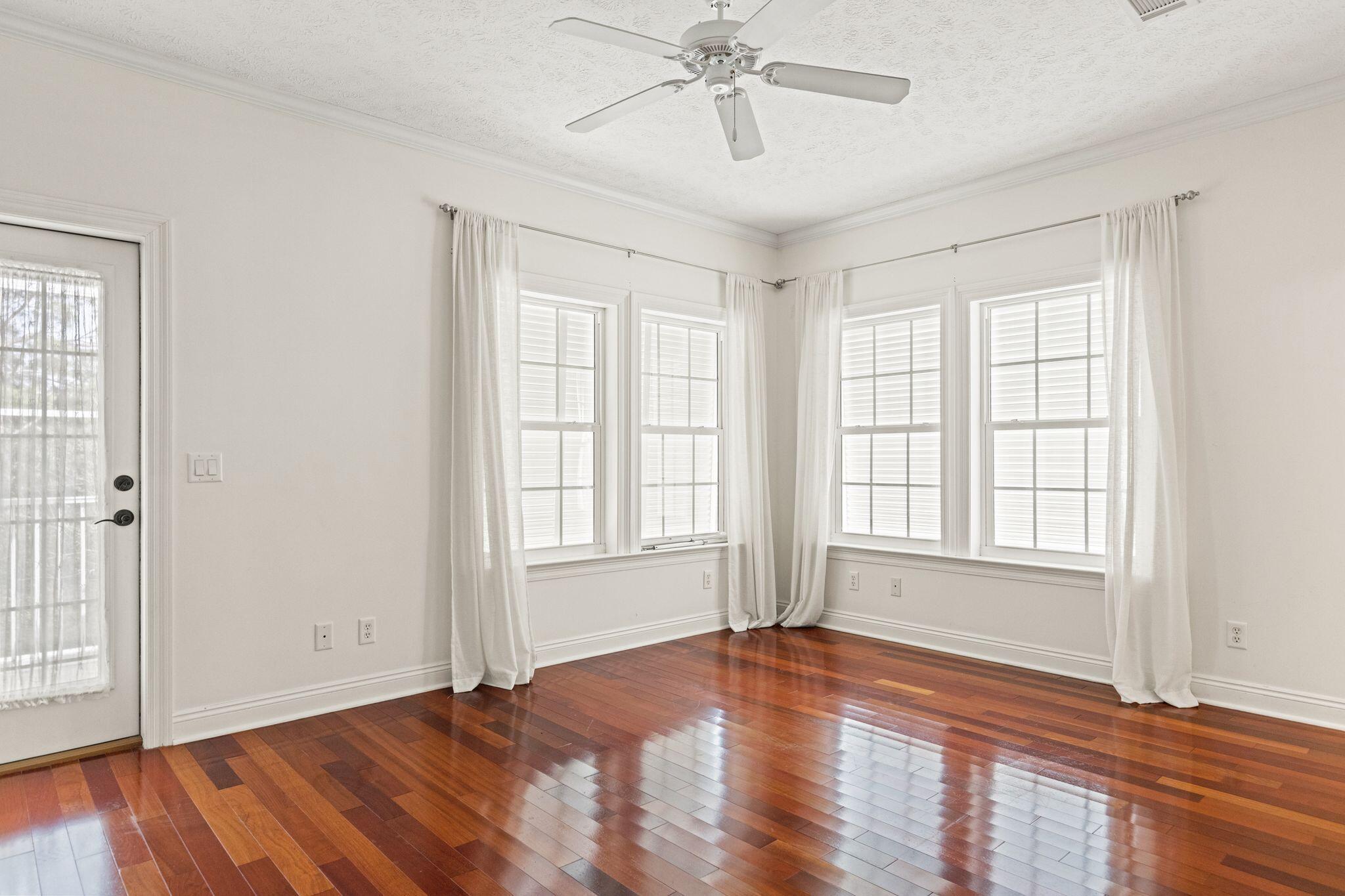 31 Seabreeze Place Inlet Beach, FL 32461 - Photo 38 of 67 an empty room with wooden floor chandelier and windows